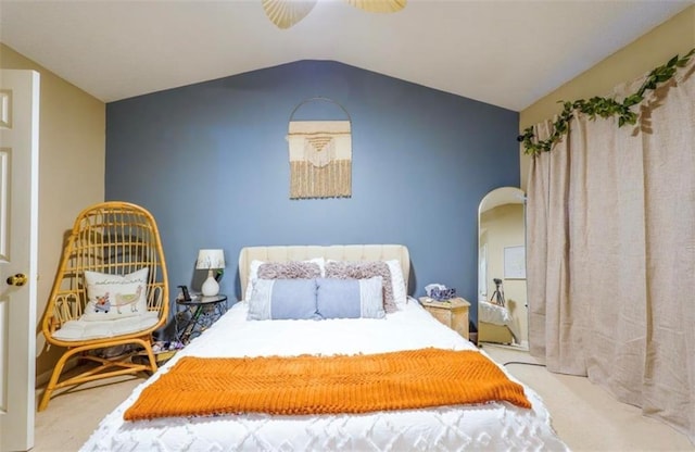 bedroom with ceiling fan, light colored carpet, and vaulted ceiling