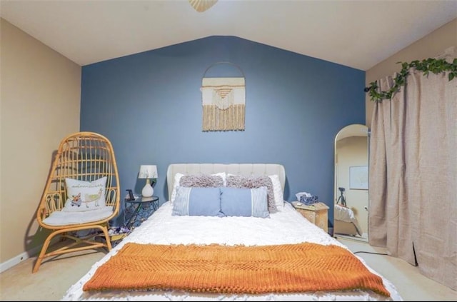 carpeted bedroom with lofted ceiling