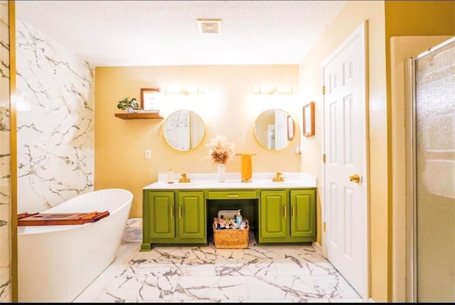 bathroom with vanity, independent shower and bath, and a textured ceiling