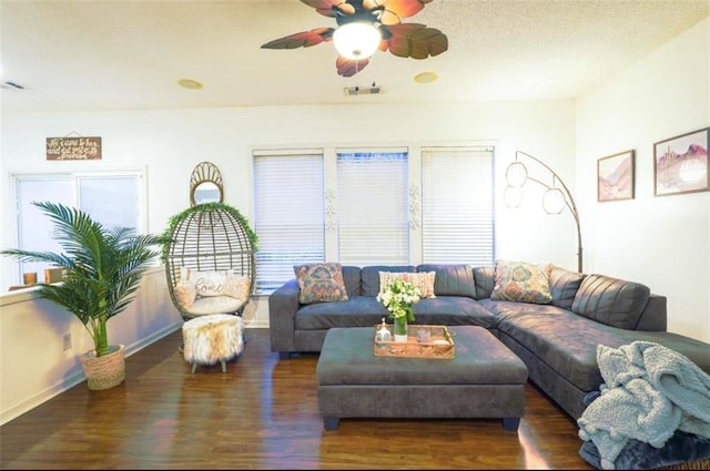 living room with ceiling fan, dark hardwood / wood-style flooring, and plenty of natural light