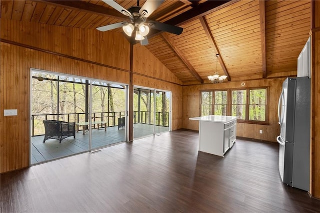 unfurnished living room with dark wood-style flooring, wood walls, beam ceiling, and wooden ceiling