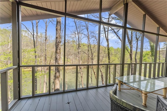 sunroom / solarium featuring ceiling fan and beamed ceiling