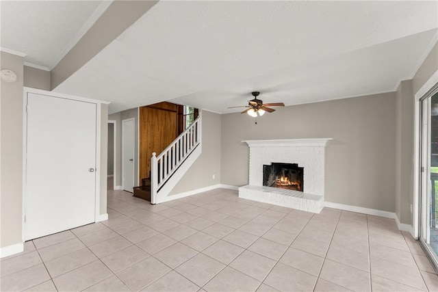 unfurnished living room with stairway, light tile patterned floors, a ceiling fan, and visible vents