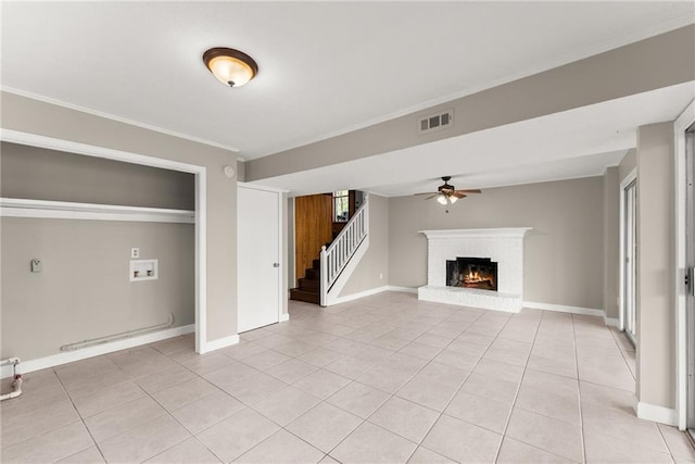 unfurnished living room with ceiling fan, ornamental molding, and baseboards