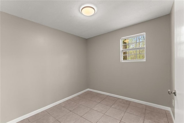 unfurnished room featuring baseboards, light tile patterned floors, and visible vents