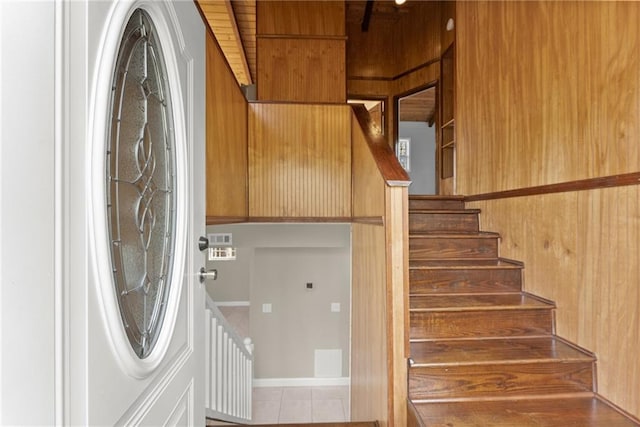 kitchen with wood walls, a sink, appliances with stainless steel finishes, and wooden ceiling
