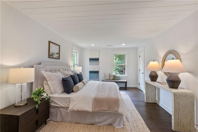 bedroom with dark hardwood / wood-style floors