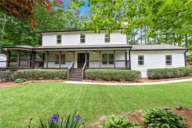 view of front of house featuring covered porch and a front lawn