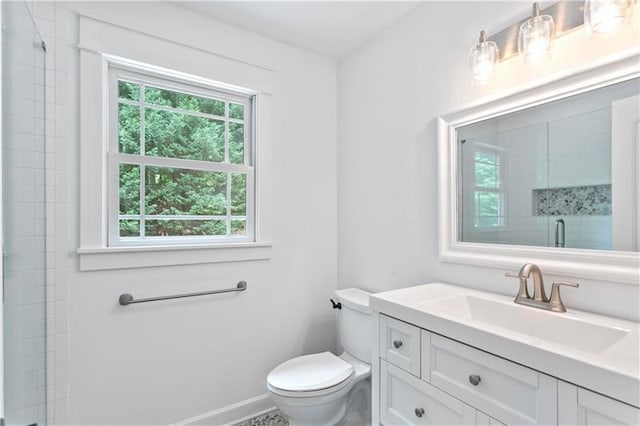 bathroom with vanity, an enclosed shower, and toilet