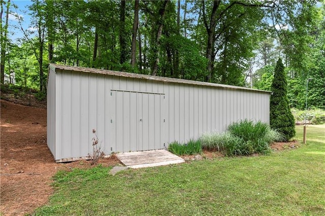 view of outbuilding with a lawn