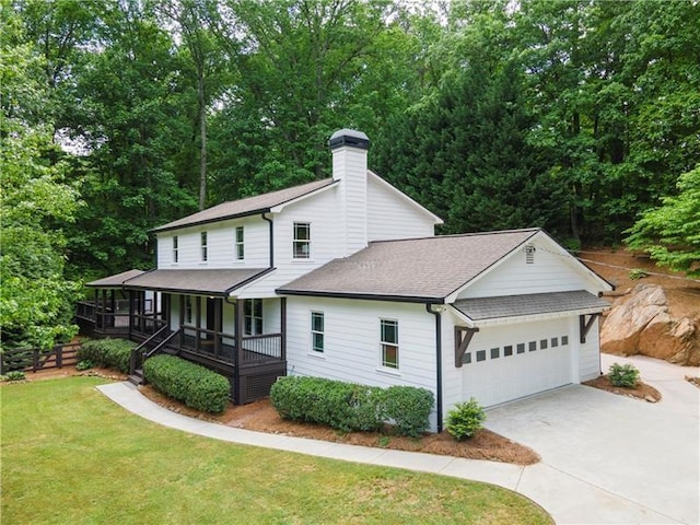 view of front facade featuring a porch, a garage, and a front yard