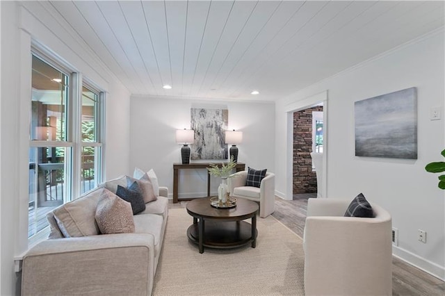 living room featuring hardwood / wood-style flooring, ornamental molding, and wood ceiling