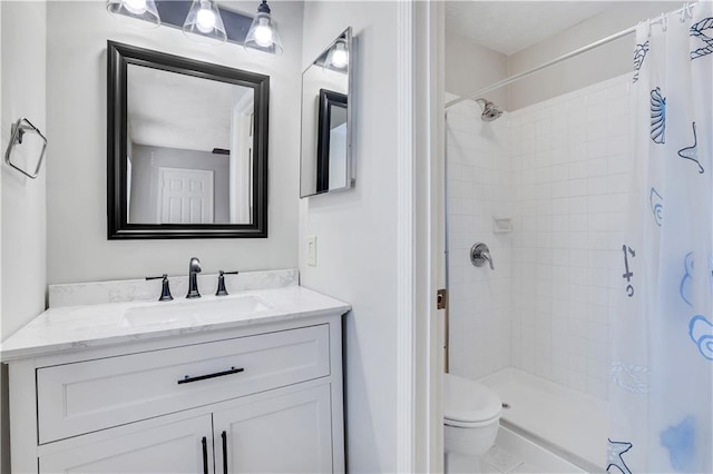 bathroom with vanity, toilet, and walk in shower