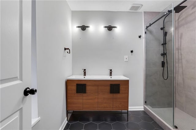 bathroom with vanity, an enclosed shower, and tile patterned flooring