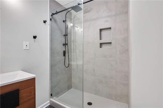 bathroom featuring vanity and a shower with shower door