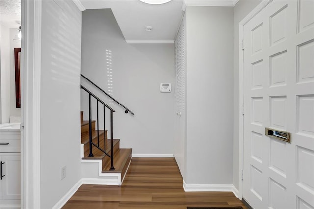 foyer entrance featuring ornamental molding and hardwood / wood-style floors