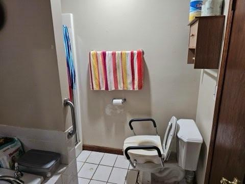 bathroom with tile patterned floors and toilet
