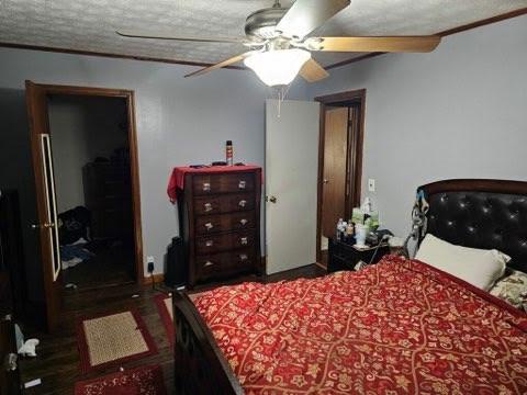 bedroom with a textured ceiling and ceiling fan