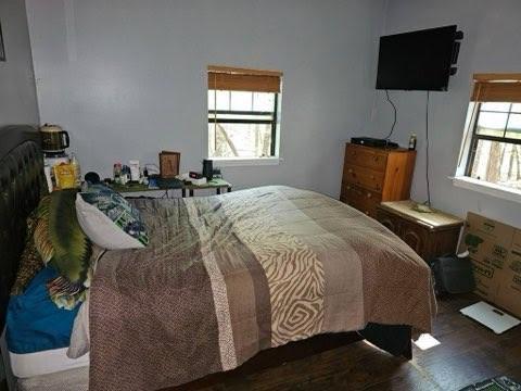 bedroom with dark wood-type flooring