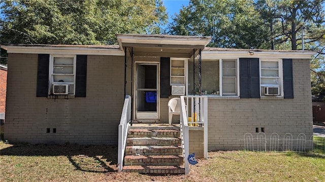 view of front of home featuring a front yard and cooling unit