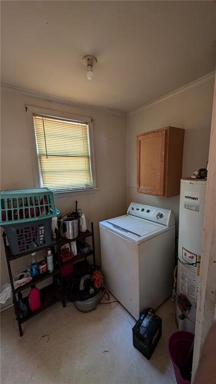 washroom with washer / dryer, cabinets, and gas water heater