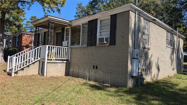 view of side of home with a yard and cooling unit