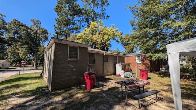 back of property featuring a lawn