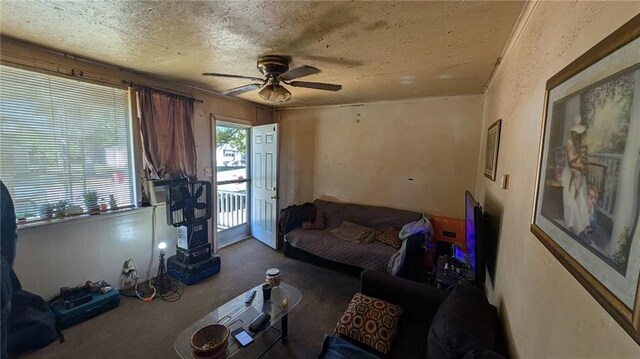 living room with a textured ceiling and ceiling fan