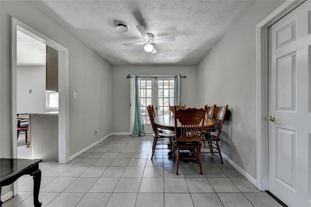 dining room featuring french doors, ceiling fan, a textured ceiling, and light tile patterned floors