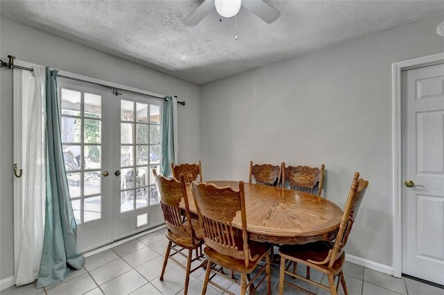 dining area featuring french doors, a textured ceiling, ceiling fan, and light tile patterned floors