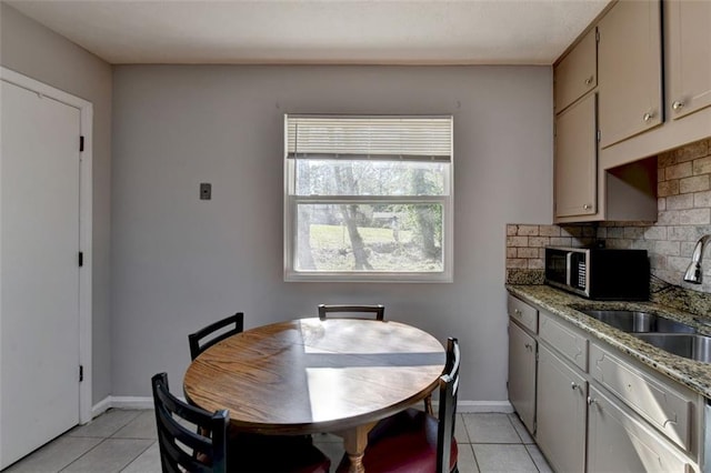 dining area with sink and light tile patterned flooring