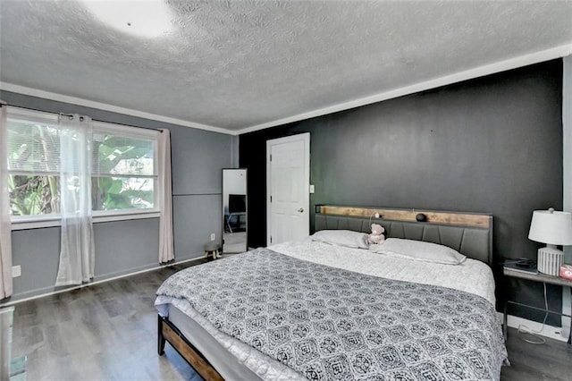 bedroom with ornamental molding, dark hardwood / wood-style floors, and a textured ceiling