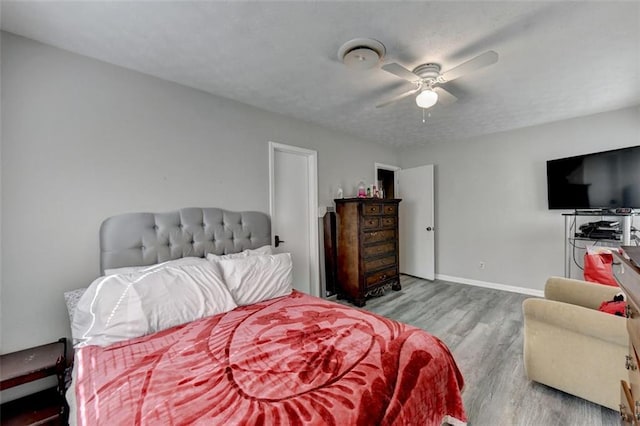 bedroom featuring ceiling fan and light hardwood / wood-style flooring