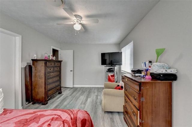 bedroom featuring light hardwood / wood-style floors and ceiling fan