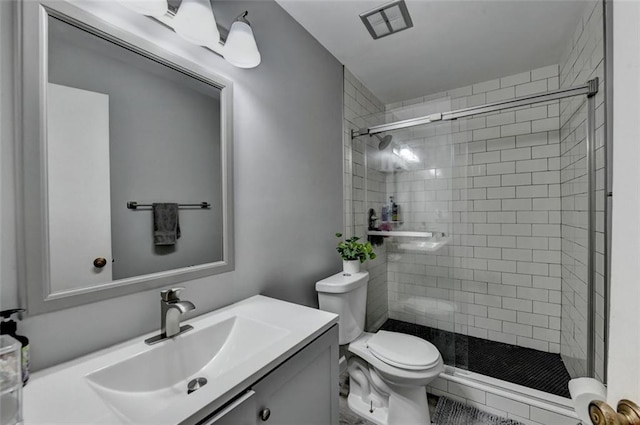 bathroom with vanity, toilet, and an enclosed shower