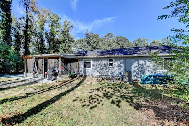 rear view of house with a patio area and a lawn