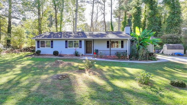 ranch-style home with a storage shed, a porch, and a front lawn