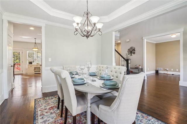 dining area with a notable chandelier, dark hardwood / wood-style flooring, and ornamental molding