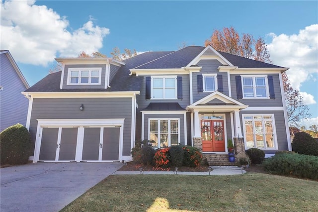 view of front facade with a front yard, french doors, and a garage