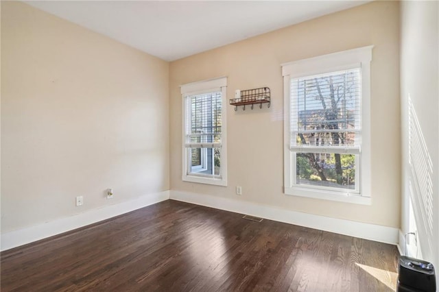 unfurnished room featuring dark wood-type flooring