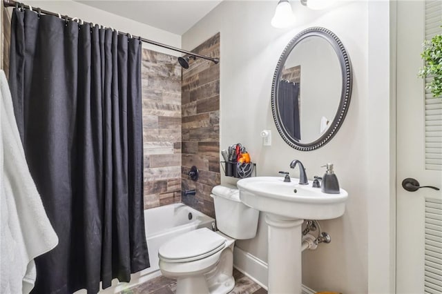 bathroom featuring shower / bathtub combination with curtain and toilet