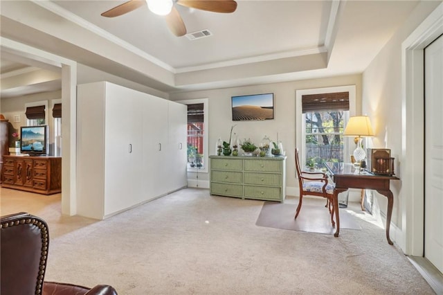 office area with carpet, a raised ceiling, and ceiling fan