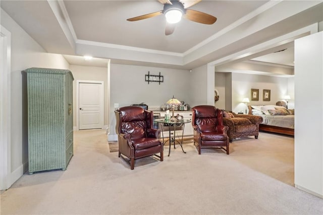 living area featuring a raised ceiling, light carpet, ceiling fan, and ornamental molding