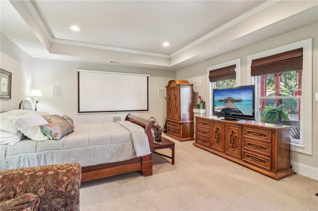 bedroom with light colored carpet, a raised ceiling, and crown molding