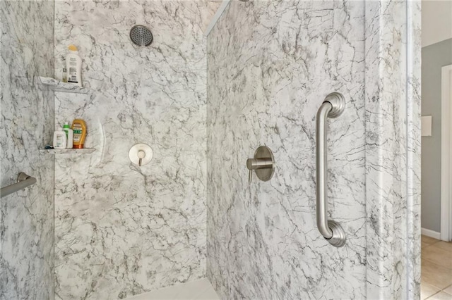 bathroom featuring a tile shower and tile patterned floors