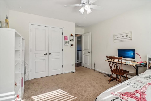 carpeted bedroom featuring a closet and ceiling fan