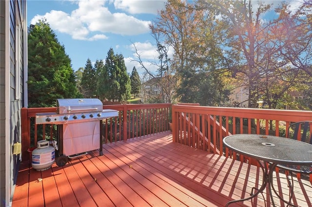 wooden deck featuring a grill