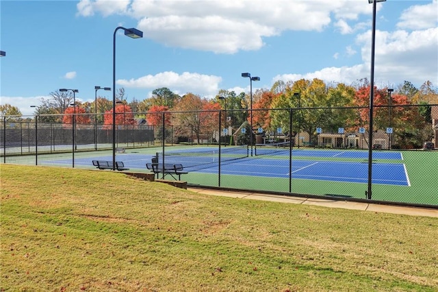 view of sport court with a yard