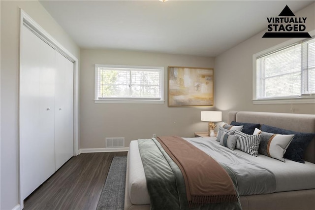 2311 Cherry Blossom Dr SW, Atlanta, GA 30331 - bedroom with multiple windows, dark wood finished floors, a closet, and baseboards