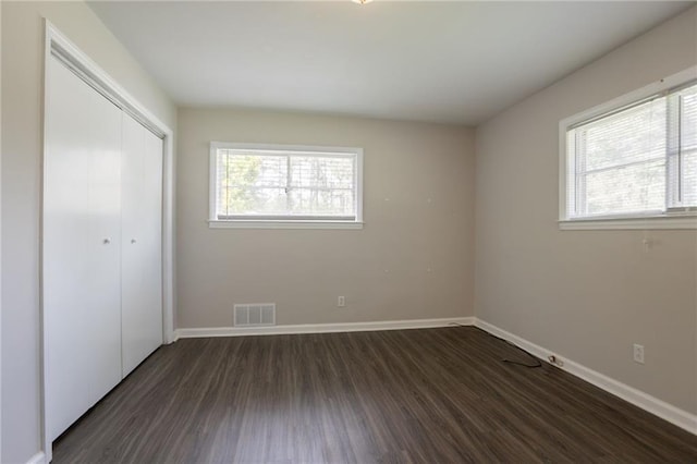 2311 Cherry Blossom Dr SW, Atlanta, GA 30331 - unfurnished bedroom with dark wood-style floors, baseboards, and a closet
